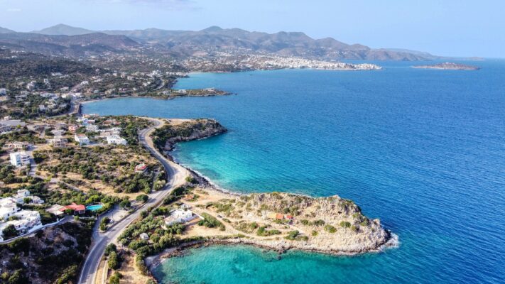 Coast Line of Aghios Nikolaos taken from the East side. the central point of the photo is Thief's Cave.It is said that  A thief used to live there at old times.Nice quiet small beach at 10 minutes east from Agios Nikolaos