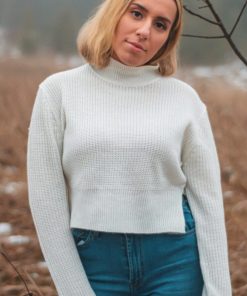 portrait photography of woman wearing white sweater and blue denim jeans